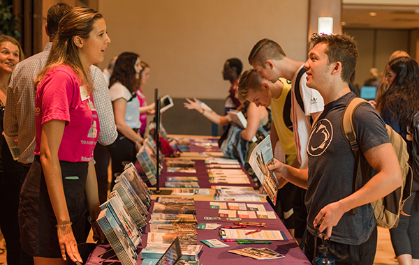 Male student speaking with female education abroad provider