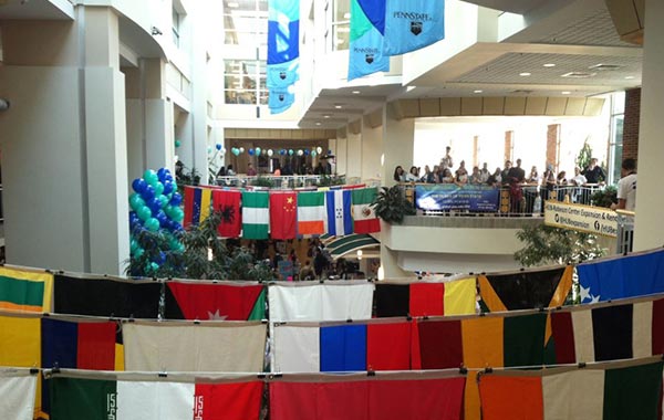 Many countries' flags hanging in a building on campus